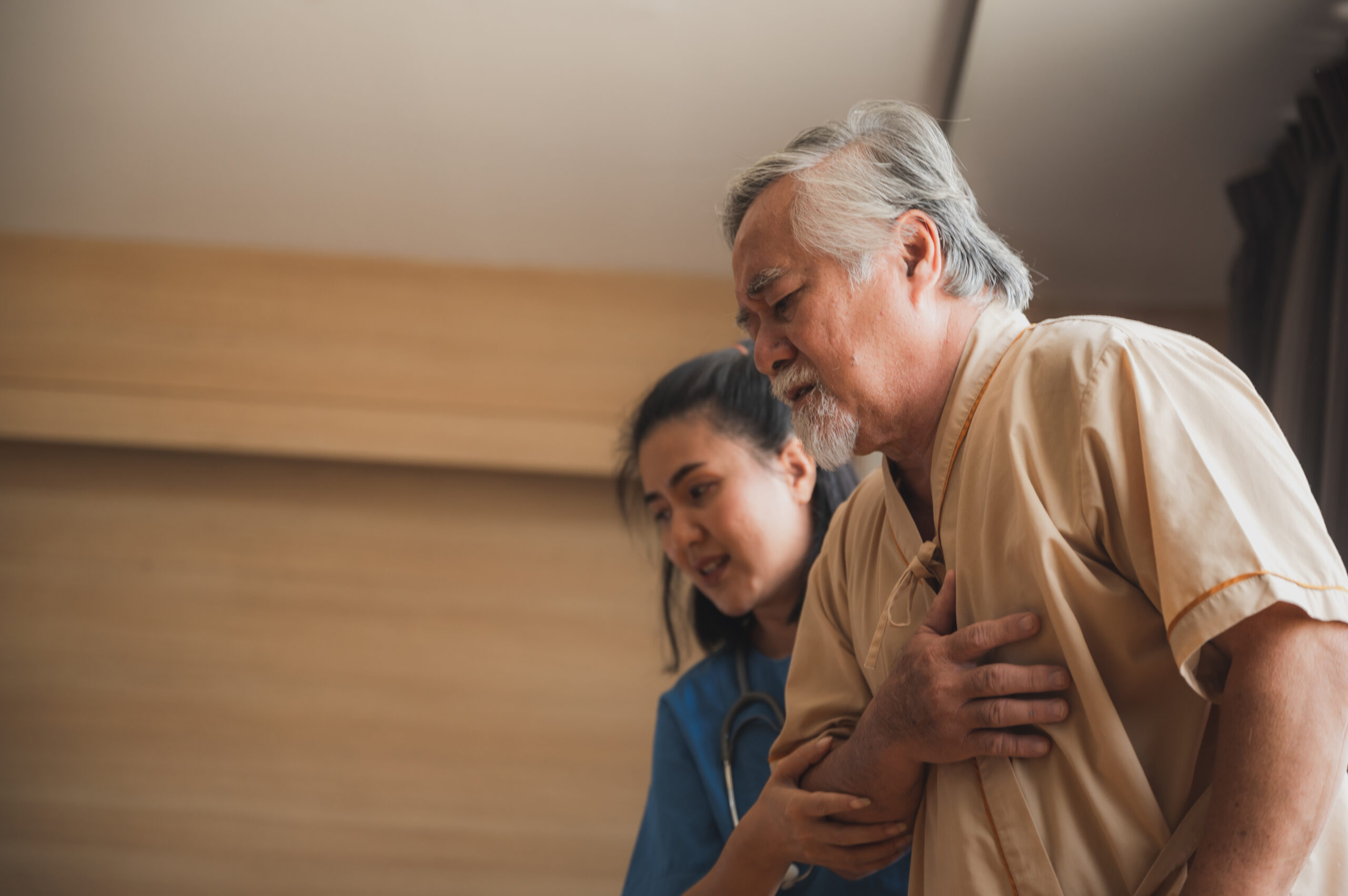 Nursing home care concept. The healthy nurse helping support and checking the elderly male patient at hospita.